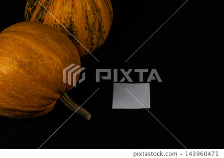 Pumpkins sit on a black surface for Halloween decoration in October Pumpkins sit on a black surface for Halloween decoration in October 143960471