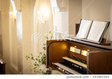 A classic image of a chapel with an organ piano. A classic image of a chapel with an organ piano. 143965563
