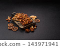 A bar of sugar free milk chocolate with pistachios, almonds, and hazelnuts. A milk chocolate bar 143971941