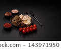 A bowl featuring slices of boiled chicken fillet, buckwheat noodles, and mushrooms 143971950