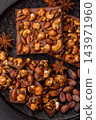 A bar of sugar free milk chocolate with pistachios, almonds, and hazelnuts. A milk chocolate bar 143971960