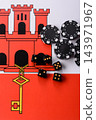 Playing cards, dice and chips on a Gibraltar flag, a gambling game of poker, blackjack or baccarat 143971967