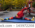Mature woman practicing yoga and stretching outdoors in an autumn park. Active senior enjoying healthy aging, fitness, and vitality through outdoor workout and mindfulness. 143972208