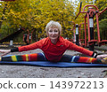 Mature woman practicing yoga and stretching outdoors in an autumn park. Active senior enjoying healthy aging, fitness, and vitality through outdoor workout and mindfulness. 143972213