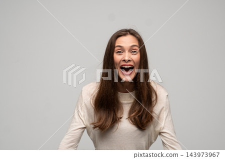 Excited young woman shouting with an open mouth, expressing happiness and surprise on a white background 143973967