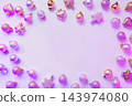 Neon frame on silver Christmas balls in colorful purple rays. Top view. Xmas. 143974080