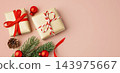 Christmas background with gift boxes and xmas ornaments on pink background, top view 143975667