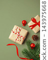 Gift boxes and christmas ornaments on green background, top view 143975668