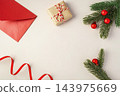 Christmas background, flat lay composition with gift box, red envelope, and pine branches 143975669