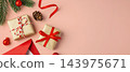 Christmas background with gift box, red envelope, and pine branches on a pink background, copy space 143975671