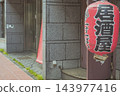 A scene in front of a shop with a red lantern hanging outside an izakaya (Japanese pub). 143977416