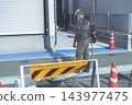 Workers carrying out exterior construction work in front of a house 143977475
