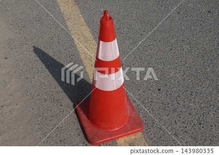traffic cone on the road 143980335