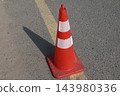 red traffic cone on the asphalt road 143980336