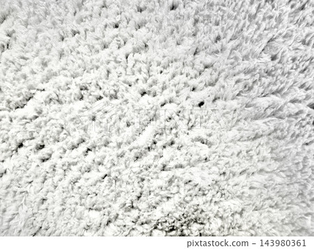ultra soft white shag rug texture embodying cozy wellness atmosphere for web design background and ad campaign featuring high pile faux fur fiber radiating serene minimalist comfort 143980361
