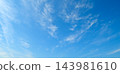 clear blue sky with a few clouds 143981610