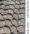 Heavy Construction Machinery Tire Tread Imprints in Sandy Soil Showing Deep Repeating Traction Pattern 143983030