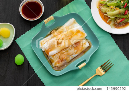 Traditional Cantonese steamed rice noodle rolls with dim sum shrimp dumplings Traditional Cantonese steamed rice noodle rolls with dim sum shrimp dumplings 143990292