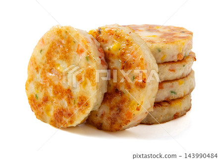 stack of golden pan-fried fish and shrimp patties isolated on white background. 143990484