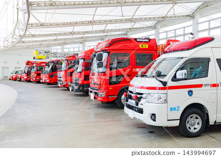 Fire trucks and ambulances waiting at the fire station Fire trucks and ambulances waiting at the fire station 143994697