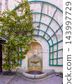 Cesky Krumlov Castle wall fountain features a stone basin in a recessed arch 143997729