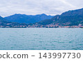 Lake Iseo in Italy under a cloudy sky with the historic lakeside town of Lovere 143997730
