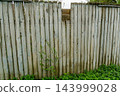 Weathered Wooden Fence Panels Along Path 143999028