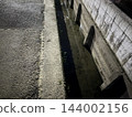 Drainage ditch on the side of the road 144002156