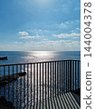 It is a seascape with a railing. 144004378