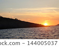 Large colony of seagulls at sunset around rocky island in Adriatic Sea near Cavtat 144005037