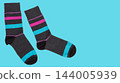 Pair of dark grey cotton socks with colorful stripes on blue background, commercial promo banner mockup with copy space for text 144005939