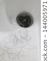 Large amount of hair in the bathroom 144005971