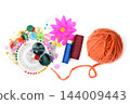 Horizontal photo of colorful sewing supplies pins safety pins buttons and orange yarn ball isolated on white background 144009443