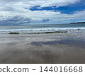 The sea and sandy beach with glimpses of blue sky through the clouds. The sea and sandy beach with glimpses of blue sky through the clouds. 144016668
