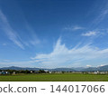 Clouds stretching across the blue sky and the green land Clouds stretching across the blue sky and the green land 144017066
