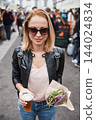 Beautiful young woman holding delicious organic salmon vegetarian burger and homebrewed IPA beer on open air beer an burger urban street food festival in Ljubljana, Slovenia 144024834