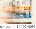 Woman traveler contemplating outdoor view from window of train. Young lady on commute travel to work sitting in bus or train 144024864