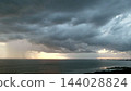 Tropical Storm Clouds Raining Over The Ocean 144028824