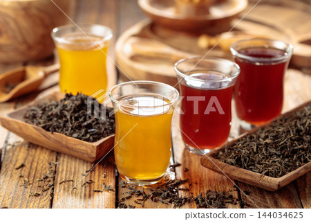 Black and green tea in small glass cups. 144034625