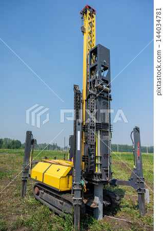 Diesel hammer drives concrete piles for a country house. Diesel hammer drives concrete piles for a country house. 144034781