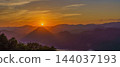 A mystical landscape of mountains bathed in the sunset and a beautiful gradient of sky. 144037193