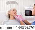 Old woman having consultation about face aesthetic with a specialist 144039870