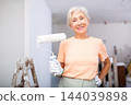 Mature woman posing with home renovation tools 144039898