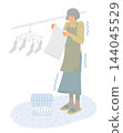 Senior women who hang their laundry outside on cold winter mornings are at increased risk of heat shock. 144045529