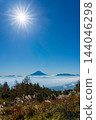 Mount Fuji floating above a sea of clouds at sunrise, as seen from Mount Amari in autumn. 144046298