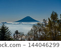 Mount Fuji floating above a sea of clouds at sunrise, as seen from Mount Amari in autumn. 144046299