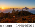 Mount Fuji floating above a sea of clouds at sunrise, as seen from Mount Amari in autumn. 144046301