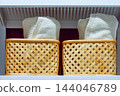 Bath towels stored in a bamboo basket 144046789